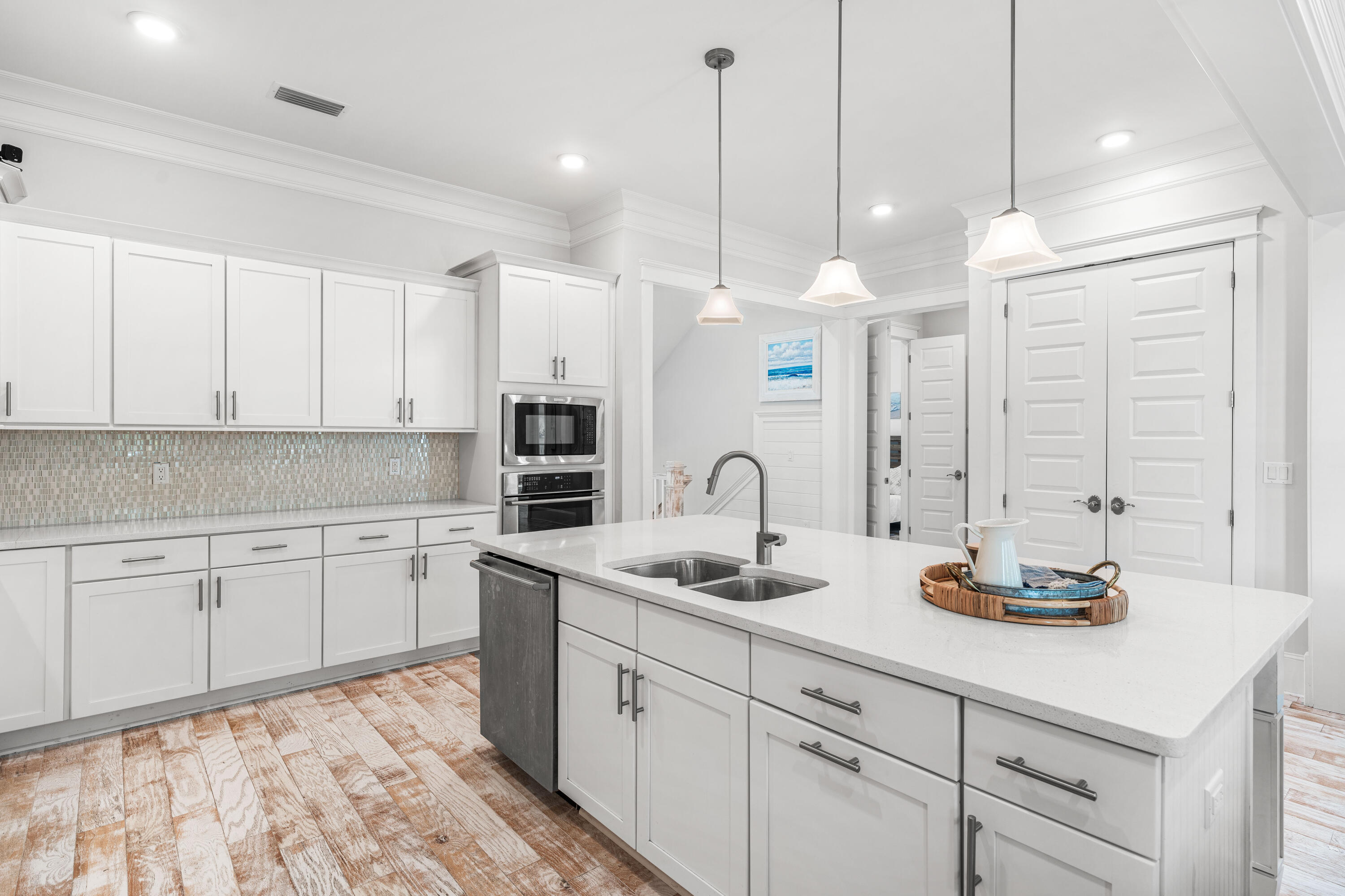 164 Clipper Street Inlet Beach, FL 32461 - Photo 10 of 75 a kitchen with stainless steel appliances granite countertop a sink a stove and white cabinets
