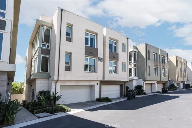 a front view of a multi story residential apartment building with yard