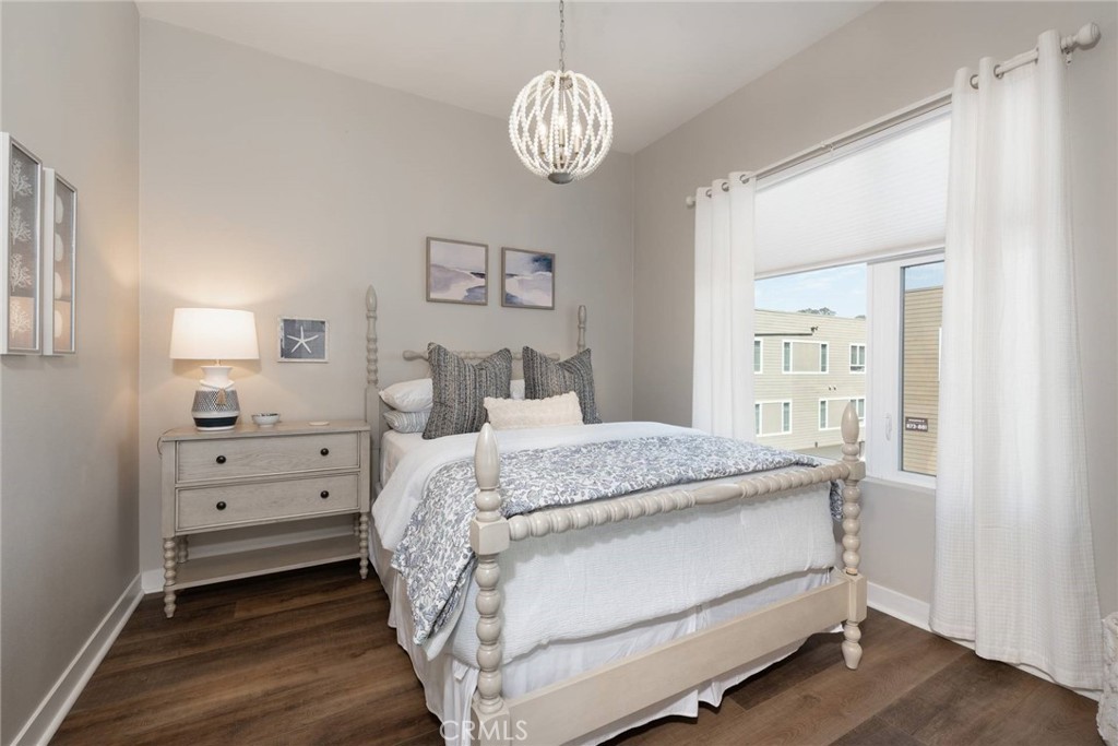 2148 Doheny Way Dana Point, CA 92629 - Photo 14 of 31 a bedroom with a bed and a chandelier