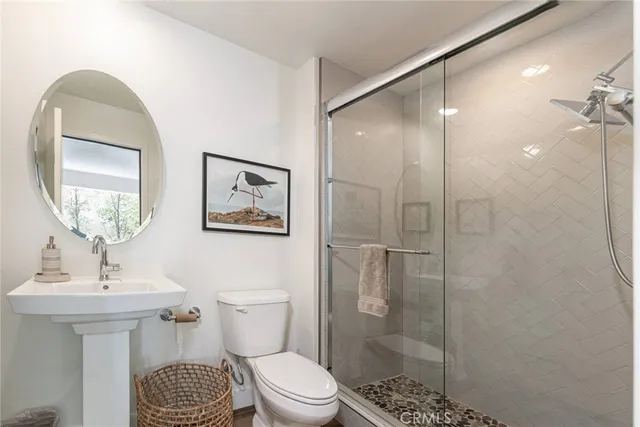 a bathroom with a toilet a sink and shower