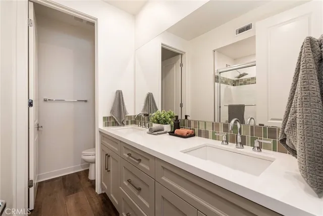 a bathroom with a double vanity sink and a mirror