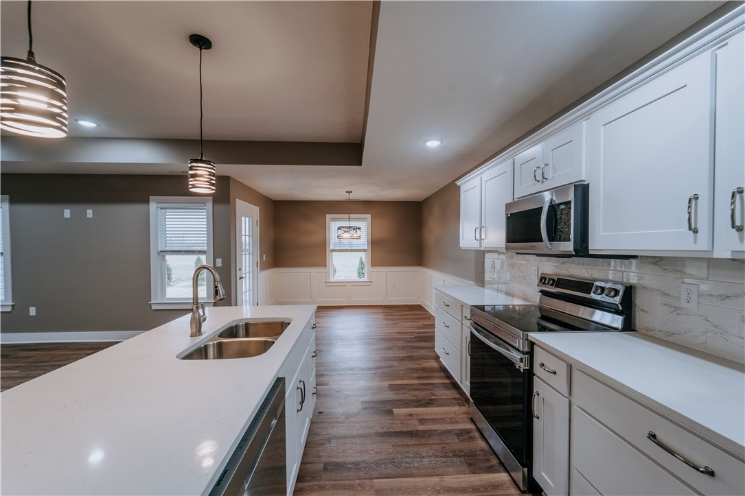 4528 West Ridgewood Road Springfield, OH 45503 - Photo 6 of 24 This kitchen showcases modern appliances and durable flooring, perfect for daily living and entertaining.