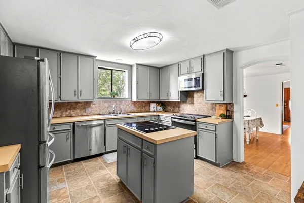 a kitchen with a stove sink and refrigerator