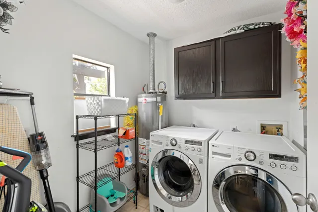 a view of a storage and utility room with washer and dryer