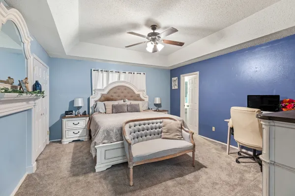 a bedroom with a bed and a chandelier
