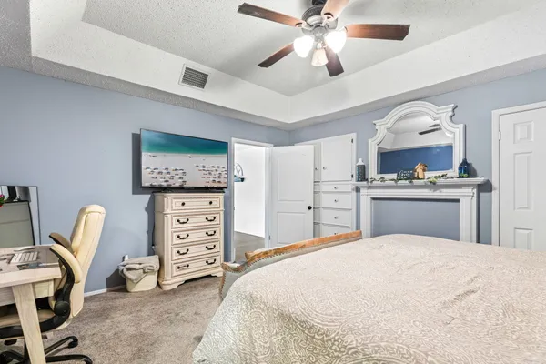 a bedroom with a bed and a chandelier