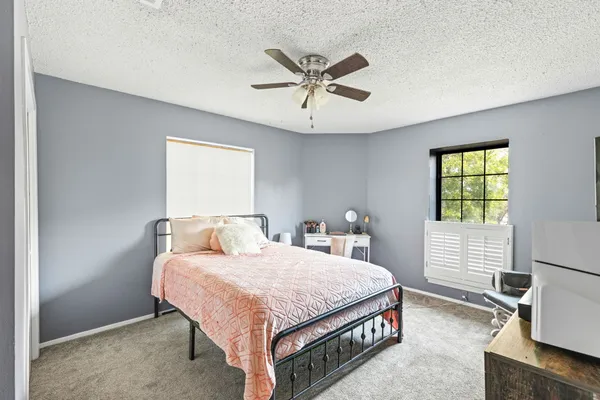 a bedroom with a bed and window