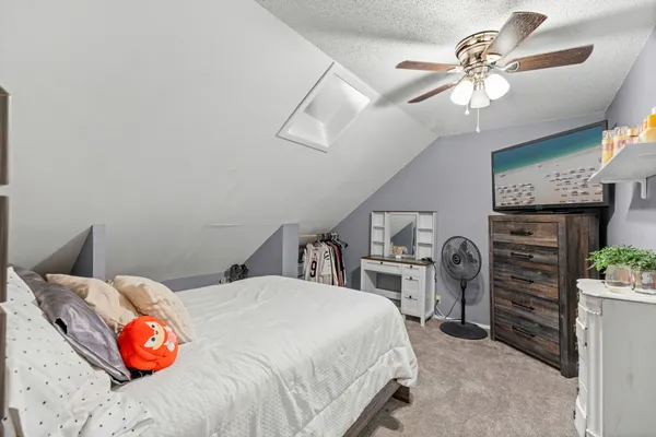 a bedroom with a bed and a chandelier