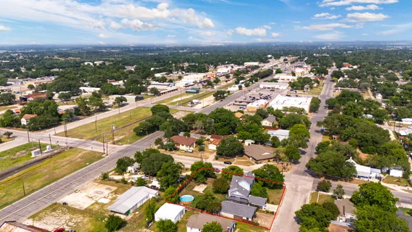 an aerial view of residential houses with outdoor space