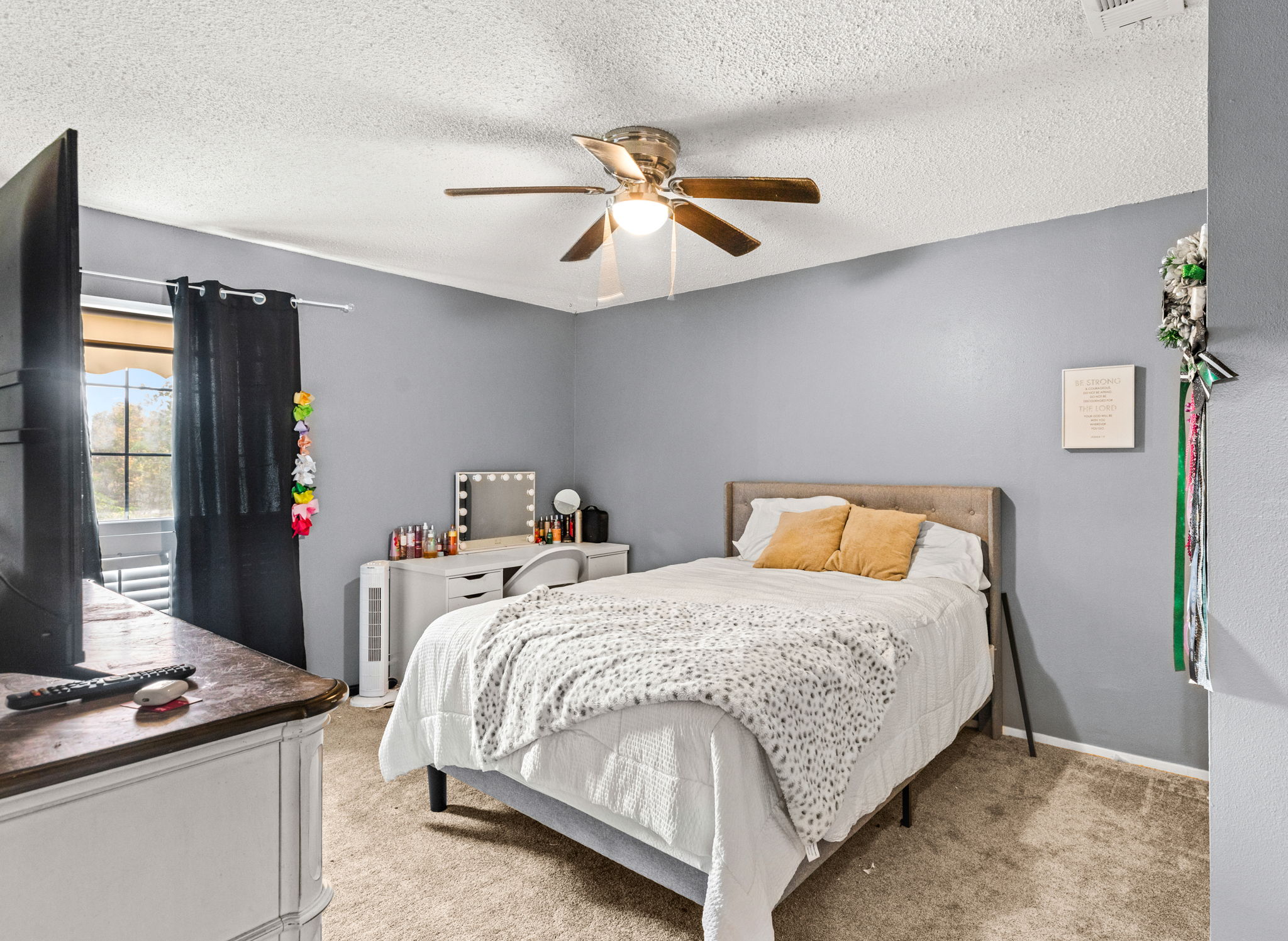 116 South Hackberry Avenue Luling, TX 78648 - Photo 22 of 39 a bedroom with a bed and a chandelier