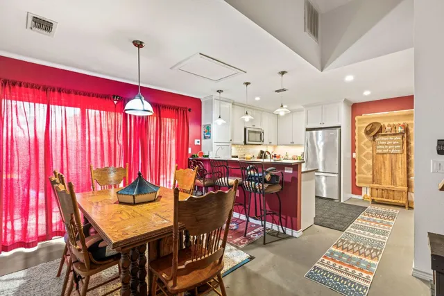 a view of a dining room with furniture and chandelier