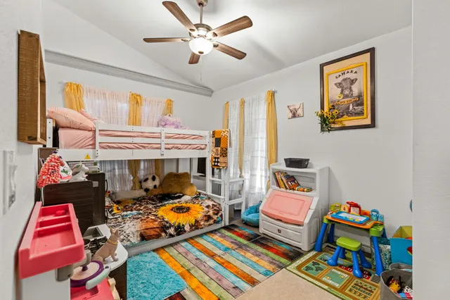 a bedroom with furniture and a baby crib