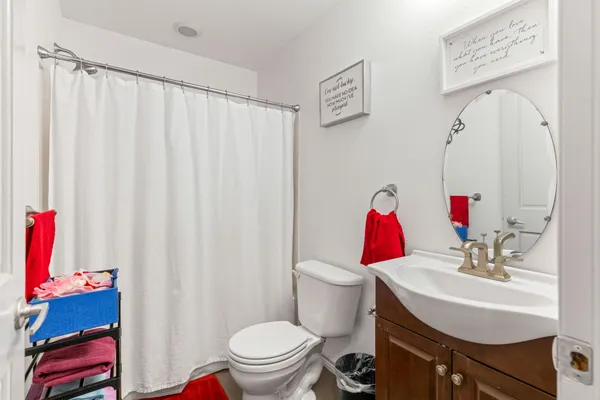 a bathroom with a sink toilet and mirror