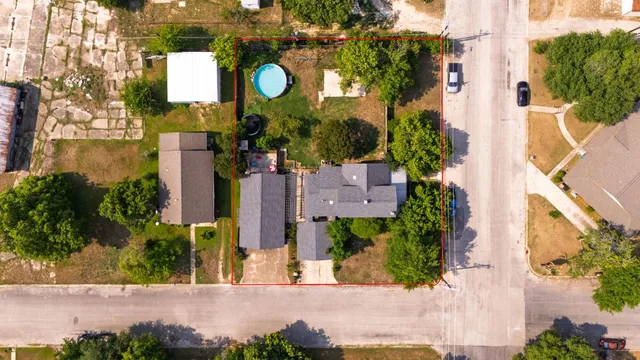 an aerial view of a house with a yard