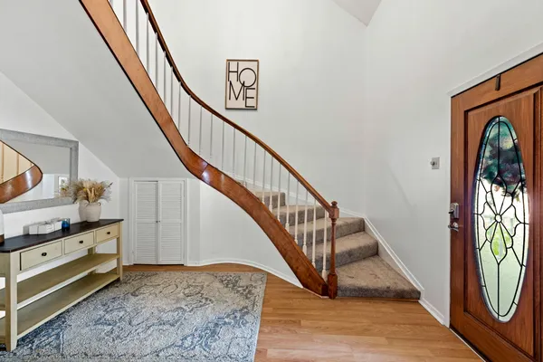 a view of entryway and hall with wooden floor