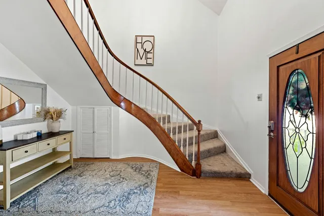 a view of entryway and hall with wooden floor