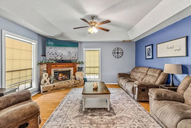 a living room with furniture and a fireplace