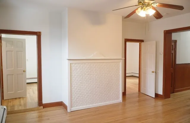 an empty room with wooden floor and closet