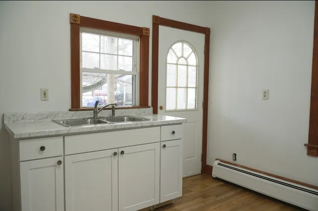 a bathroom with 2 sink and a window