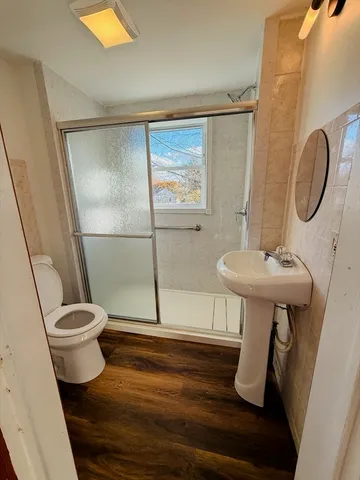 a bathroom with a sink a mirror and a shower