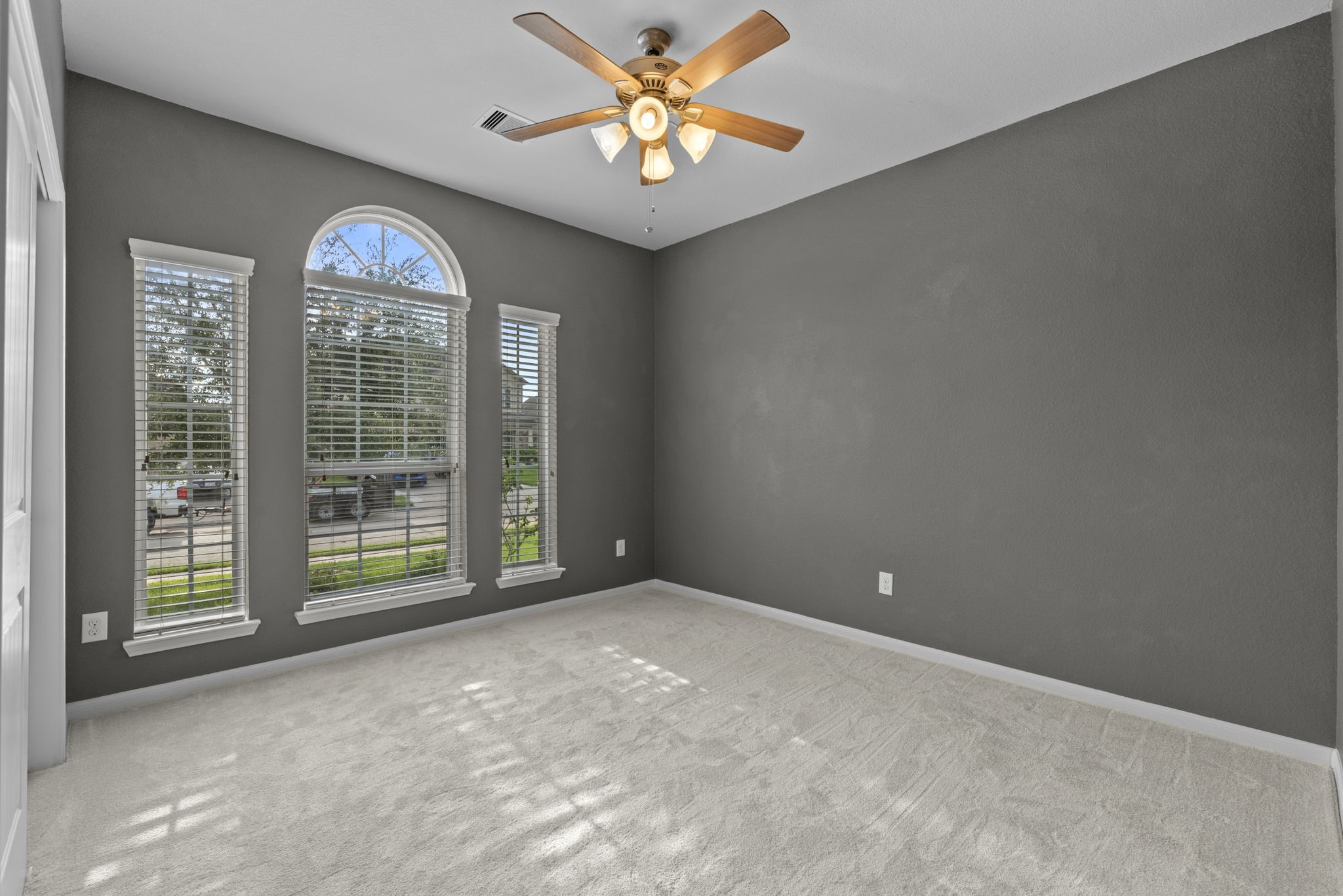 4706 Alluvial Circle Alvin, TX 77511 - Photo 11 of 39 an empty room with windows and fan