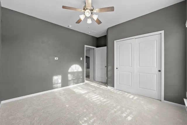 a view of a livingroom with a chandelier fan