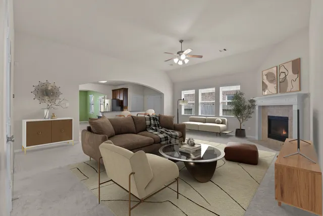 a living room with furniture potted plant a fireplace and a window