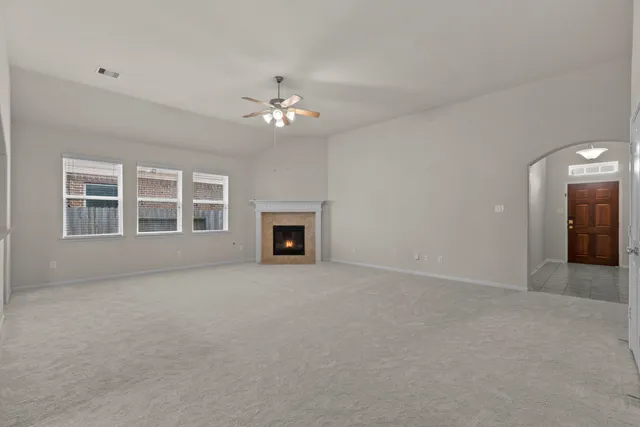 a view of empty room with a fireplace