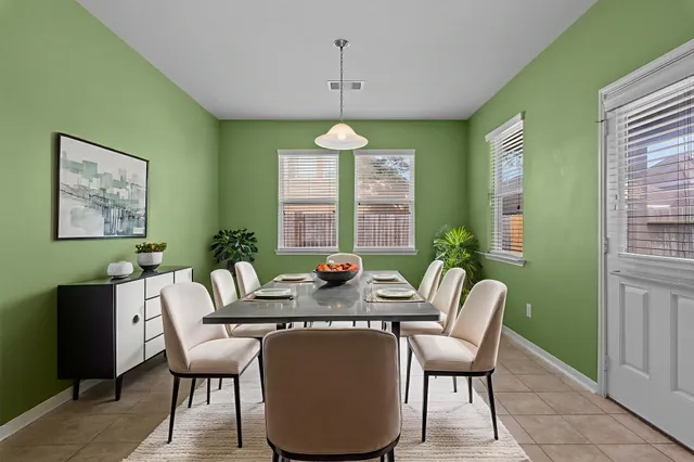 a dining room with furniture a chandelier and window