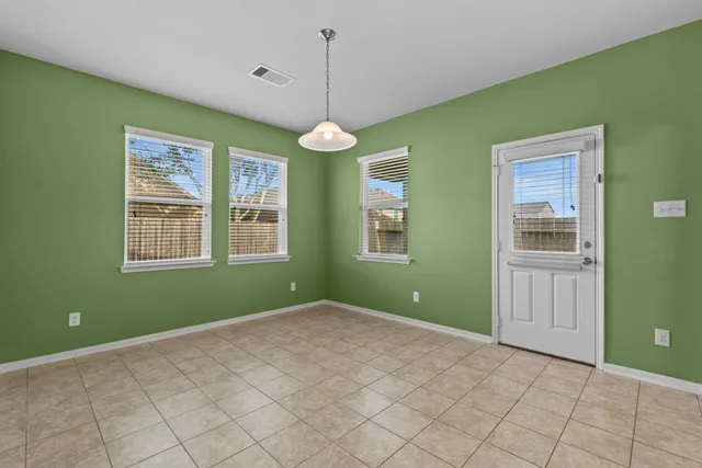 a bedroom with window and ceiling fan