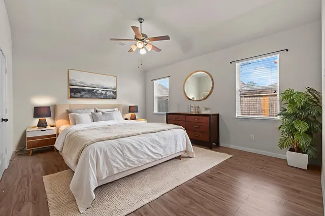 a bedroom with a bed and a chandelier