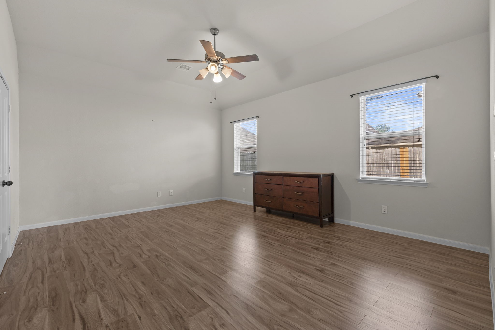 4706 Alluvial Circle Alvin, TX 77511 - Photo 23 of 39 a view of an empty room with wooden floor and a window