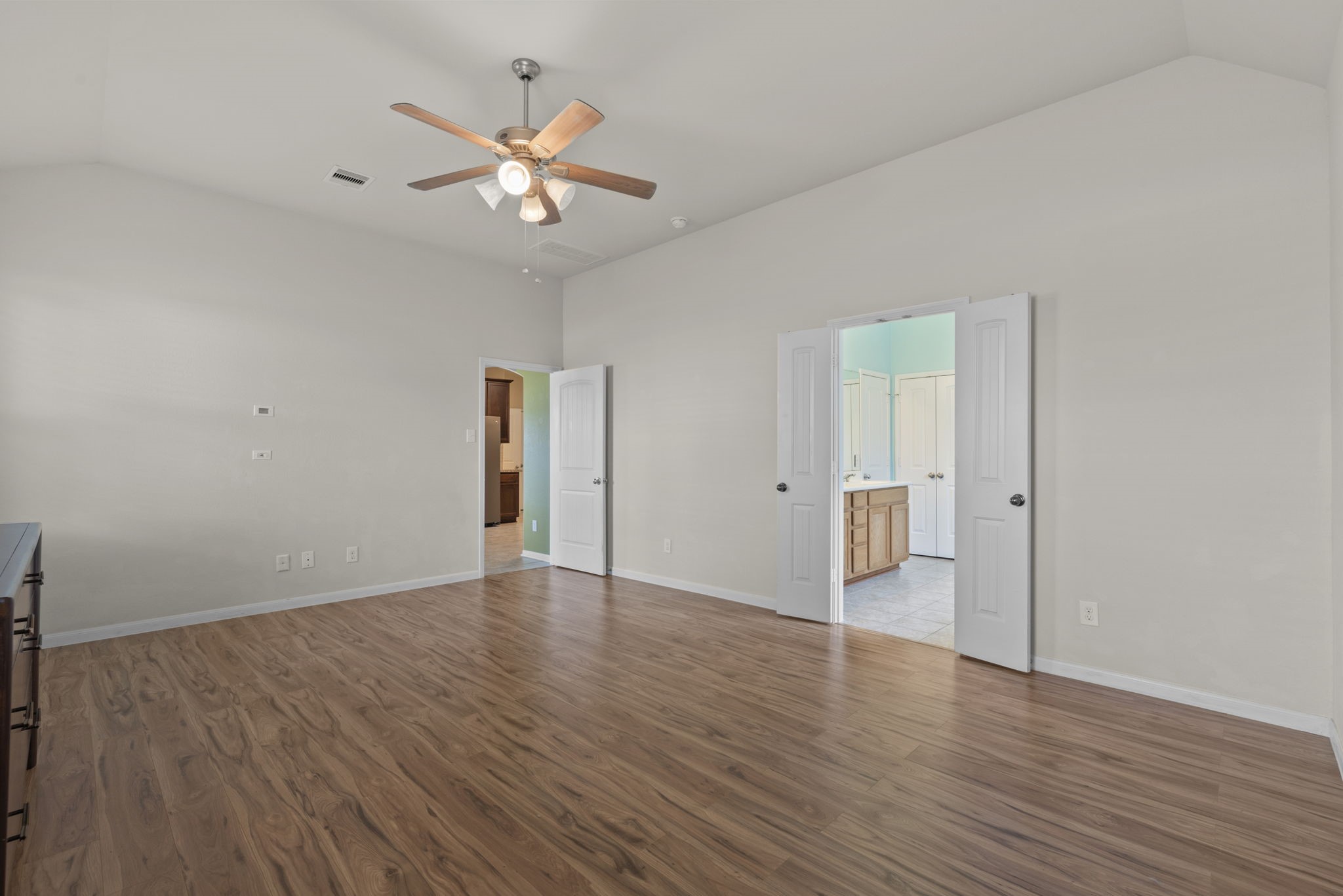 4706 Alluvial Circle Alvin, TX 77511 - Photo 24 of 39 an empty room with wooden floor and a ceiling fan