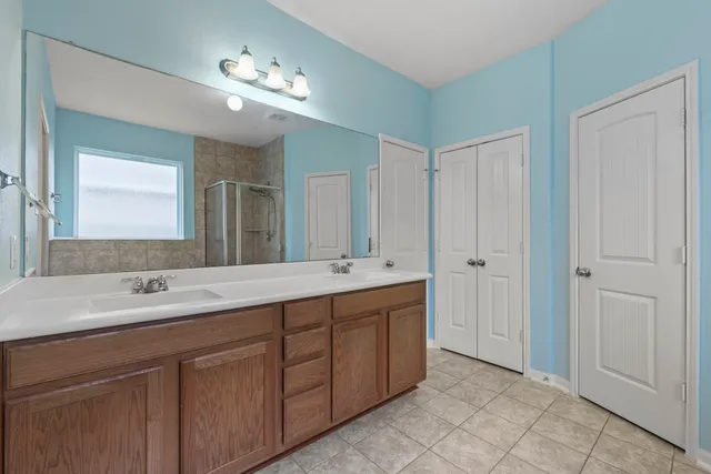 a bathroom with a double vanity sink and a mirror