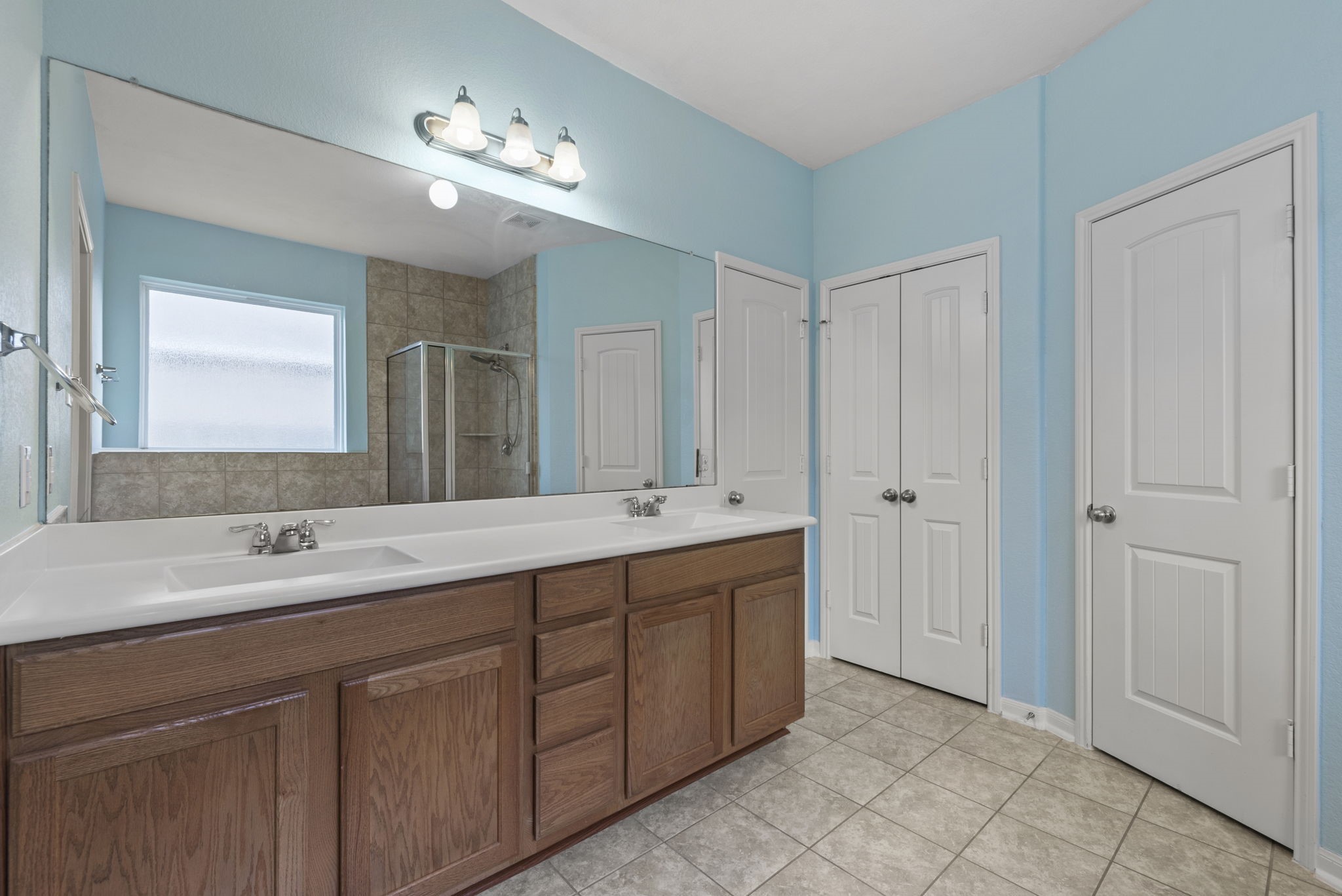 4706 Alluvial Circle Alvin, TX 77511 - Photo 25 of 39 a bathroom with a double vanity sink and a mirror