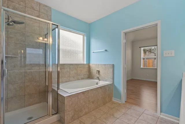 a bathroom with a bathtub and a shower