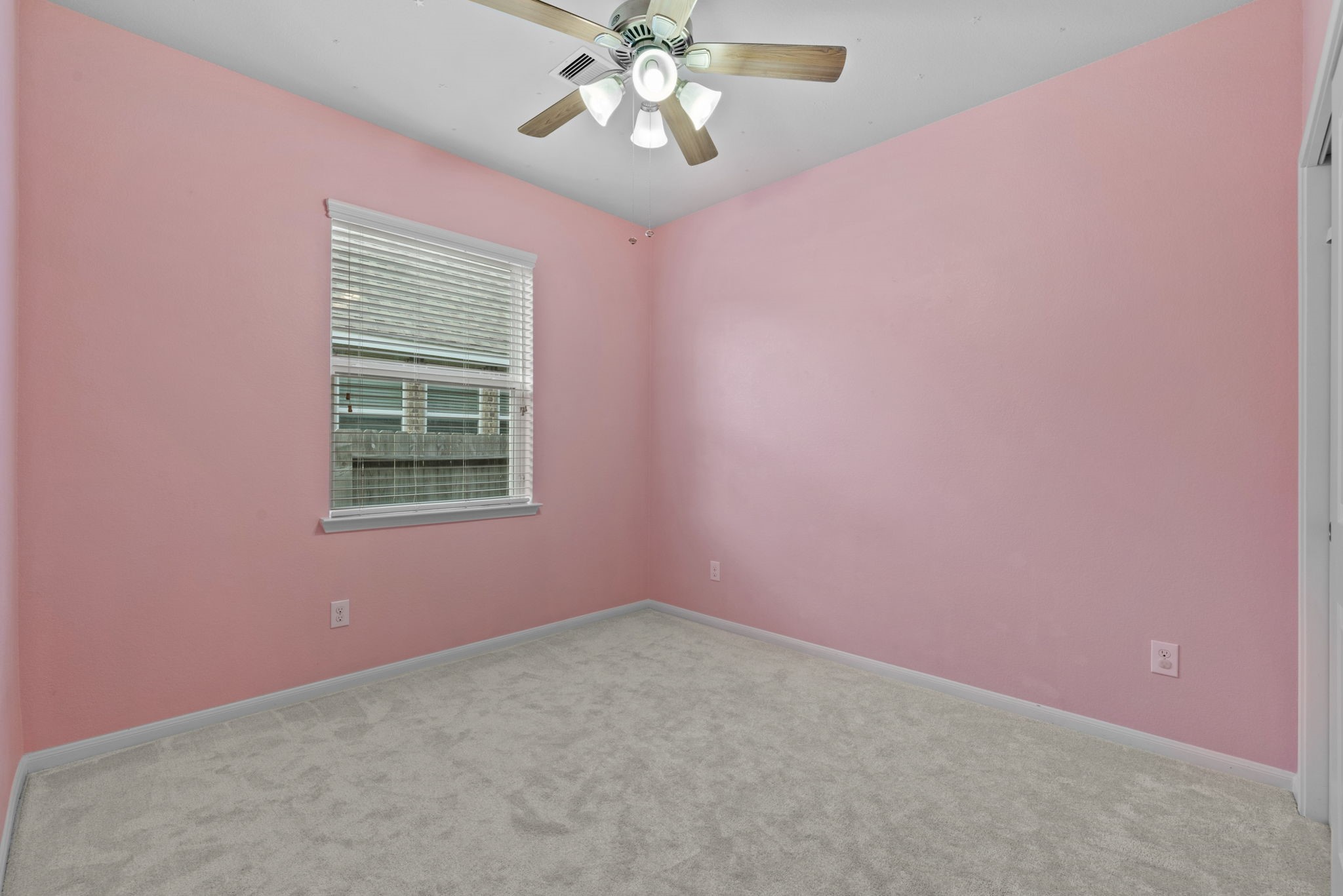 4706 Alluvial Circle Alvin, TX 77511 - Photo 31 of 39 an empty room with a chandelier fan and windows