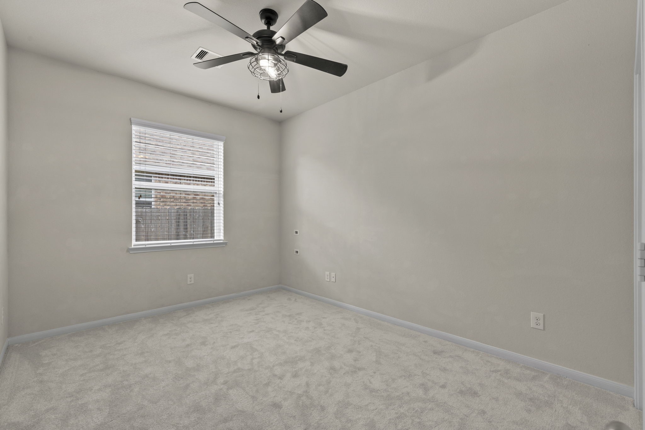 4706 Alluvial Circle Alvin, TX 77511 - Photo 33 of 39 an empty room with a window and a fan