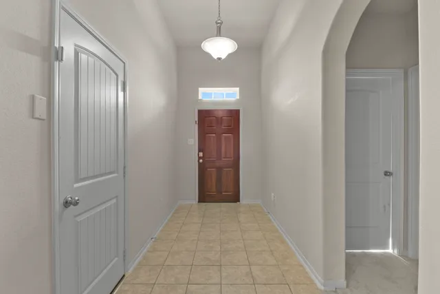 a view of a hallway with wooden shelves