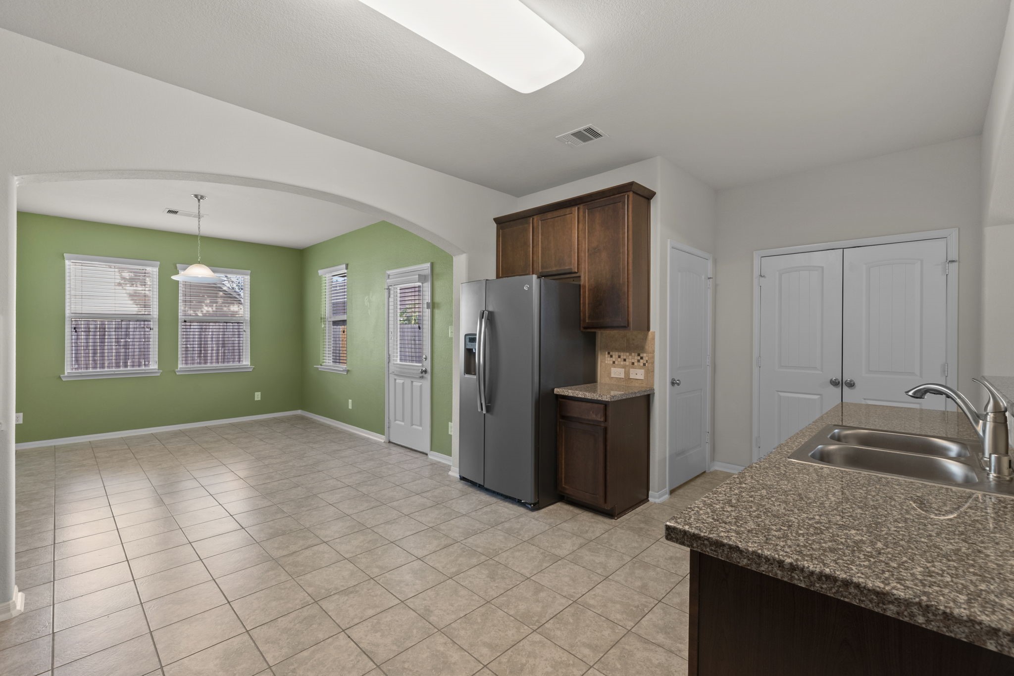 4706 Alluvial Circle Alvin, TX 77511 - Photo 7 of 39 a kitchen with stainless steel appliances granite countertop a refrigerator and a sink