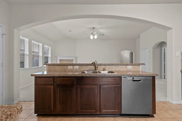 a kitchen with a sink a cabinets and wooden floor