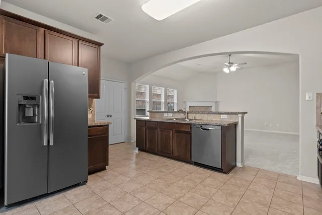 a kitchen with a sink refrigerator and microwave