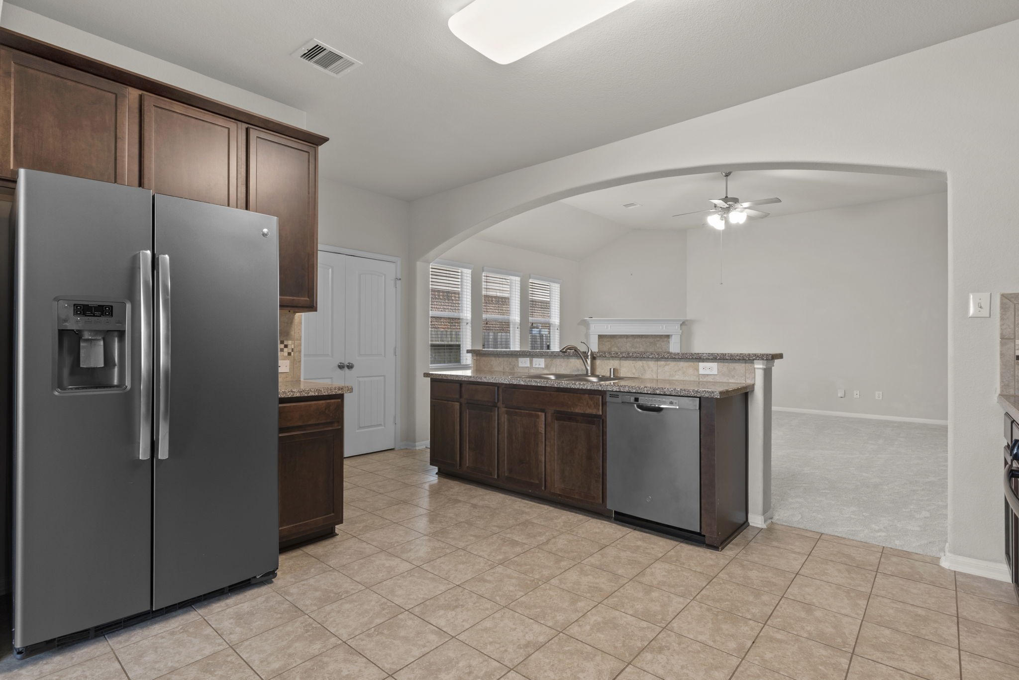 4706 Alluvial Circle Alvin, TX 77511 - Photo 9 of 39 a kitchen with a sink refrigerator and microwave