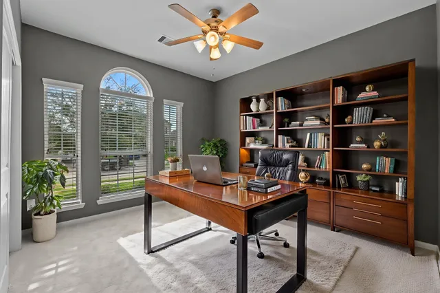 a reading room with furniture and a book shelf