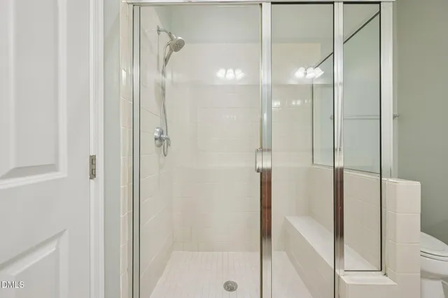 a bathroom with a glass shower door and a sink