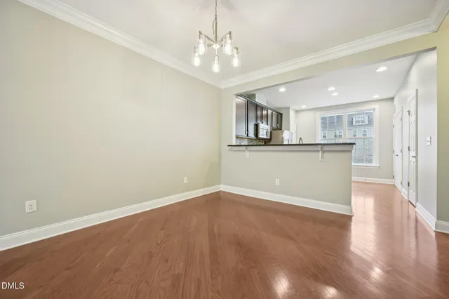 a view of a kitchen with wooden floor and a sink