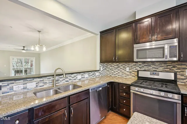 a kitchen with a sink stove and microwave