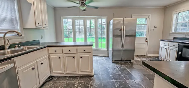 a kitchen with stainless steel appliances granite countertop a stove a sink and a refrigerator