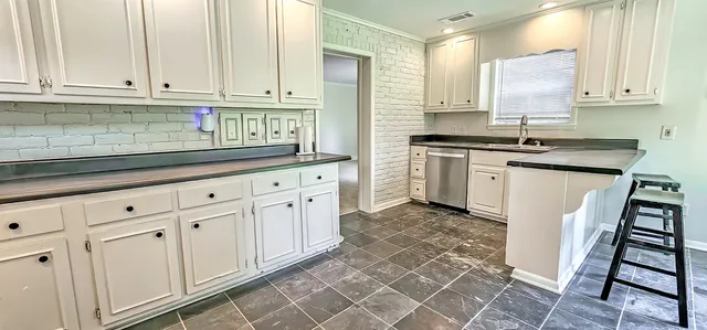 a kitchen with white cabinets and white appliances