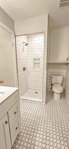 a bathroom with a sink toilet and shower